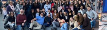 student group sitting below a rocket at a Smithsonian Museum in DC
