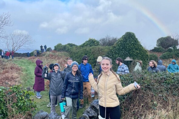 group of high school students exploring an outdoor historic site in Ireland with a rainbow in the background A Helpful Timeline to Plan Your Next Student Travel Adventure