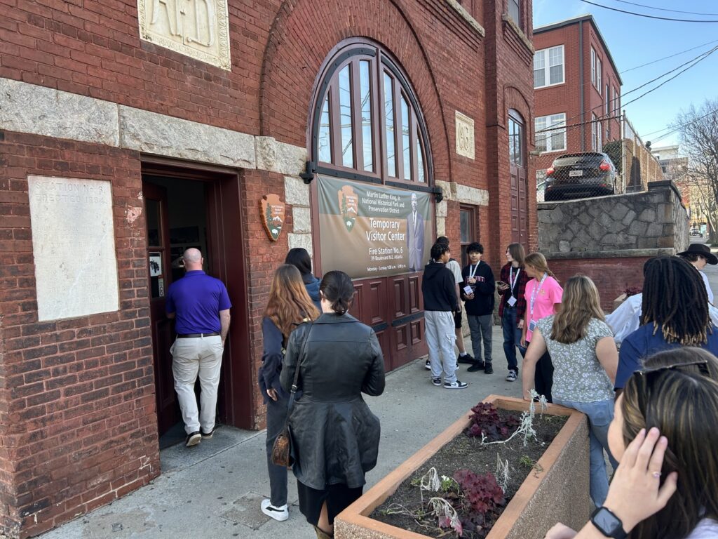 student group entering historic fire station in National MLK Historic Park