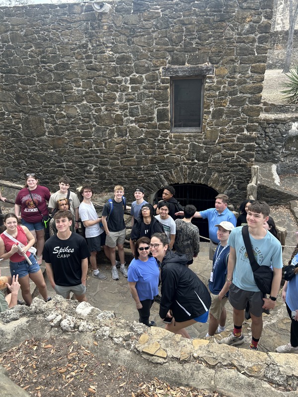 group of students exploring a historic stone structure