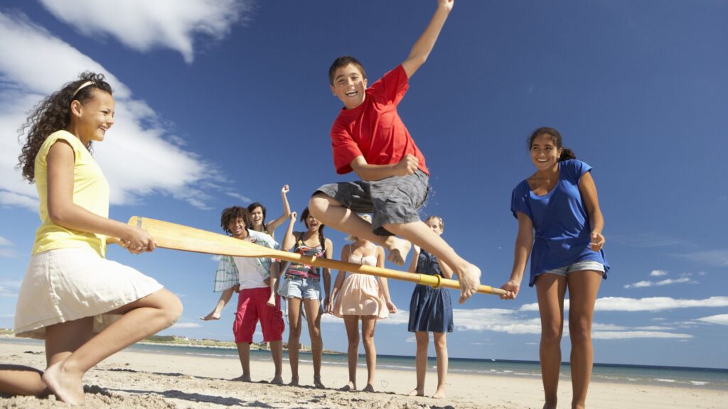 group of teens playing beach games