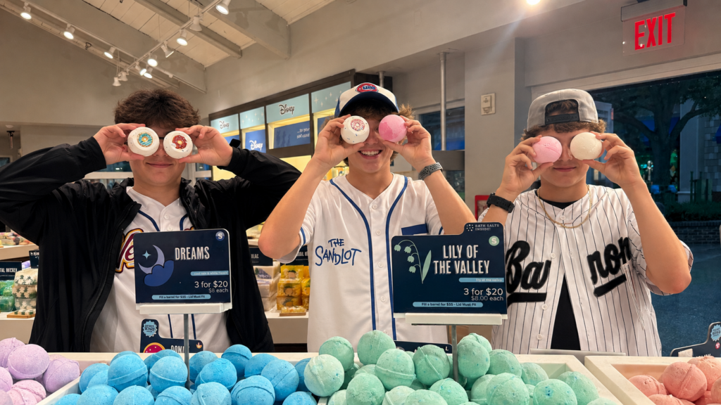 3 young people holding bath bombs in front of their eyes to be silly