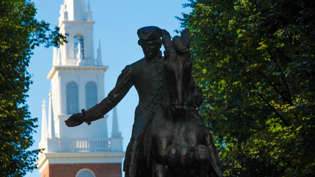 statue of paul revere in front of Old North Church steeple in background