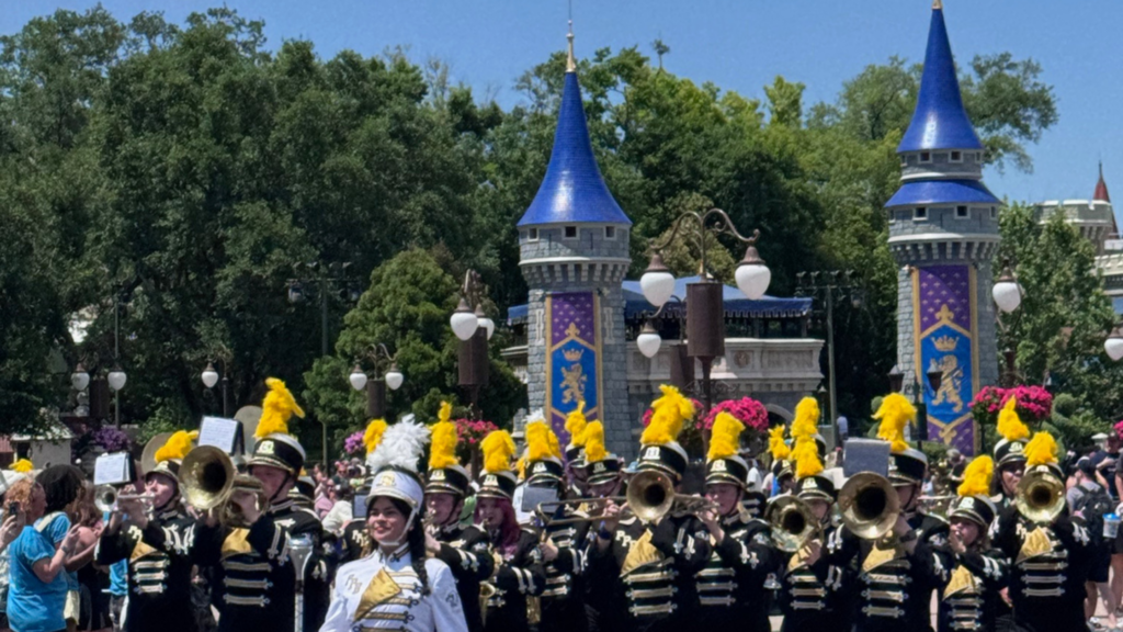 a high school marching band marching at Disney