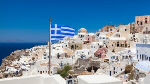 whitewashed structures on a hillside in Greece