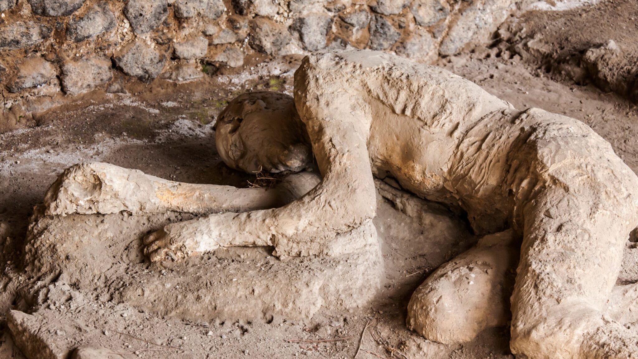ruins of Pompeii and a fallen person