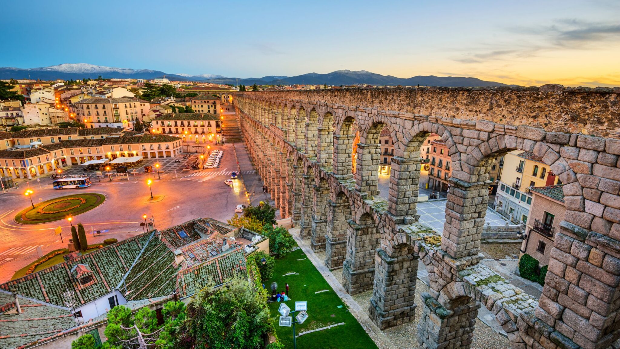 ancient aqueducts in Segovia, Spain are featured in this city view
