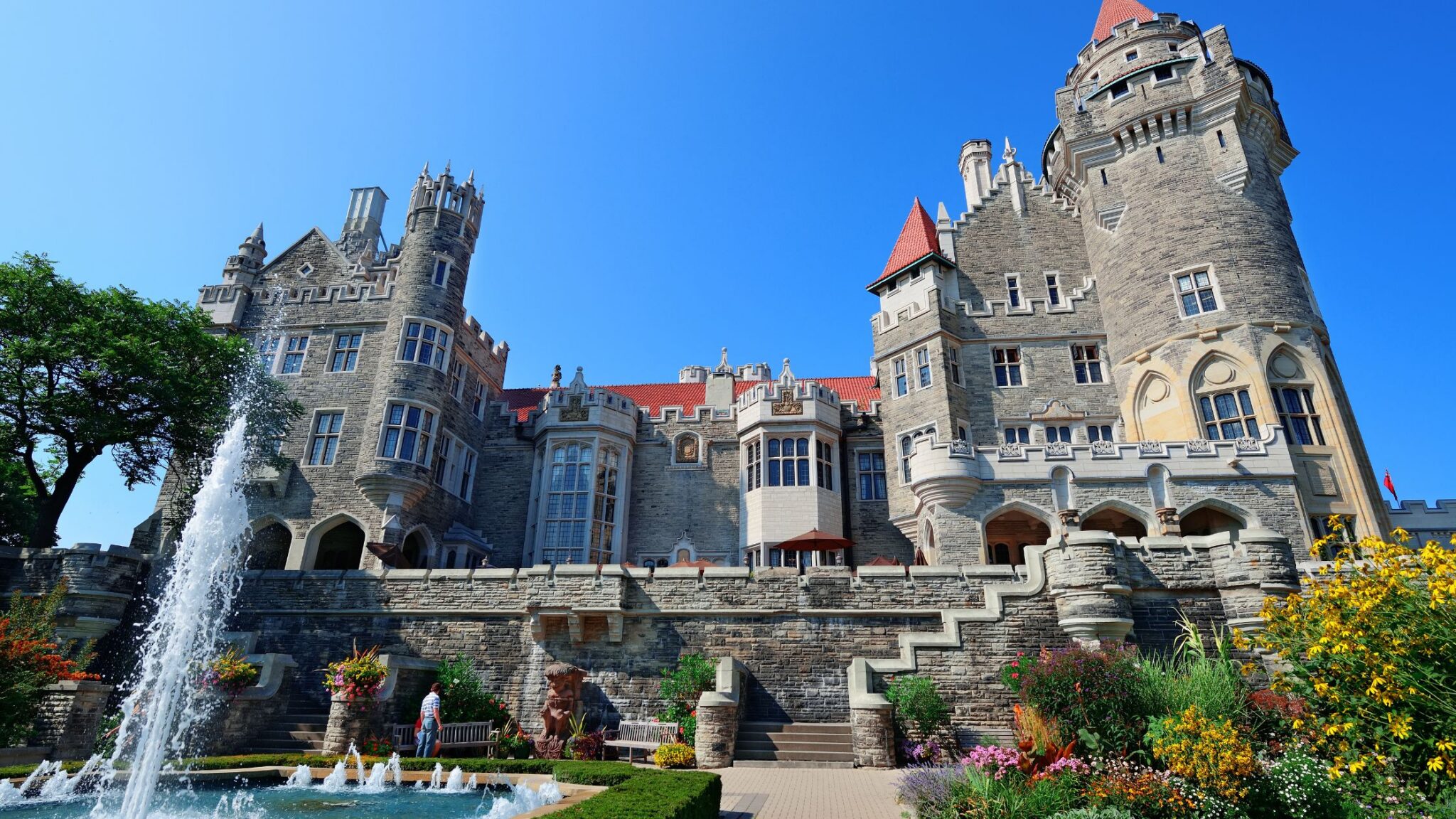 imoressive stone castle with gardens in the foreground